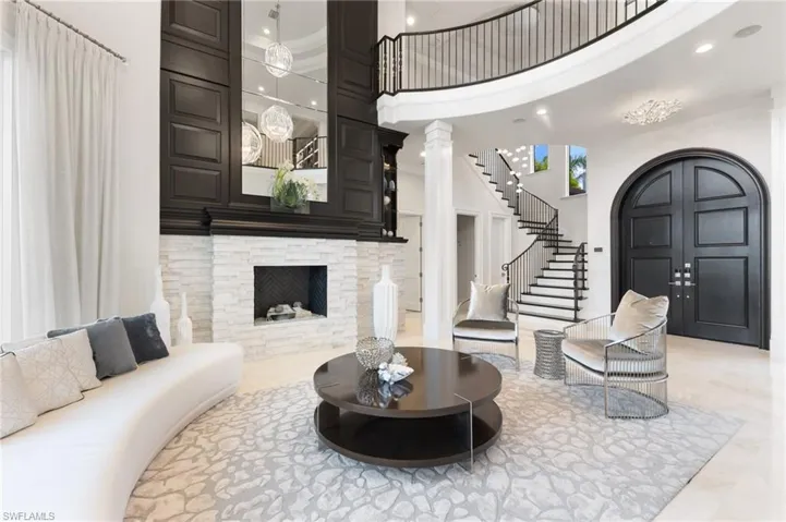 Living room featuring a fireplace and two story ceilings