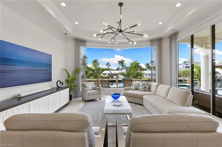 Living room with water views through frameless glass
