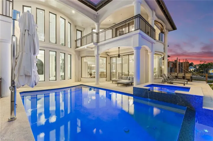 Pool at dusk with overflow hot tub