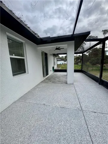 View of patio featuring a ceiling fan, a sunroom, and a lanai