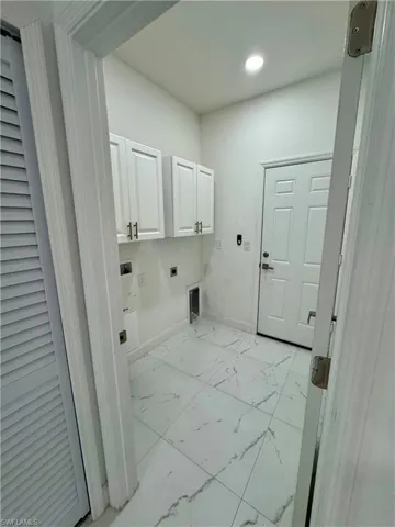 Laundry room with light marble finish floors, hookup for an electric dryer, cabinet space, washer hookup, and recessed lighting