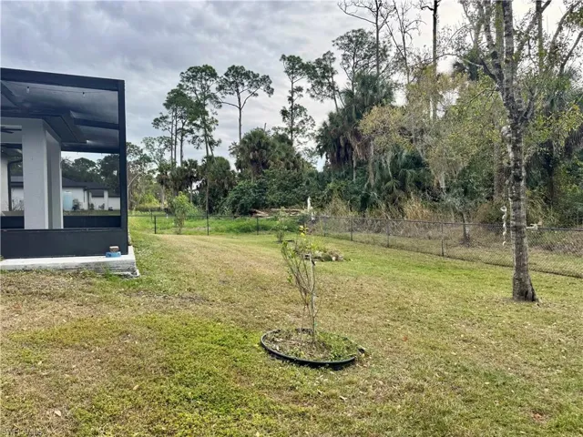 View of yard with a sunroom