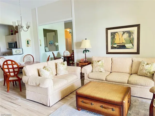 Living area featuring wood finished floors and a chandelier