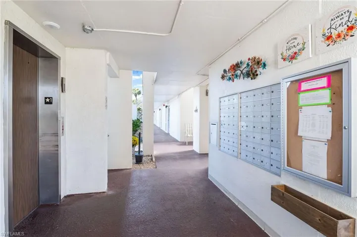 Hallway with elevator and mail area