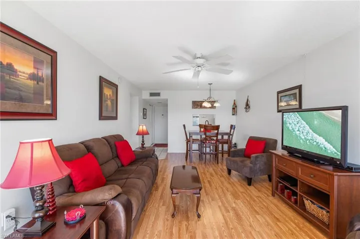Living room featuring ceiling fan and light wood-type flooring
