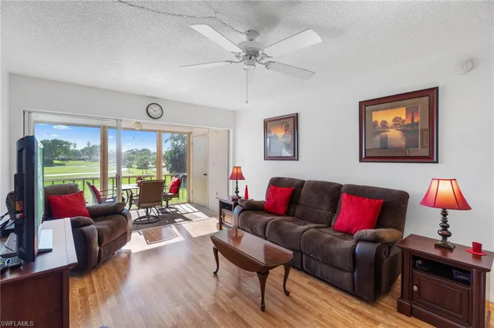 Living room featuring ceiling fan, light hardwood / wood-style floors