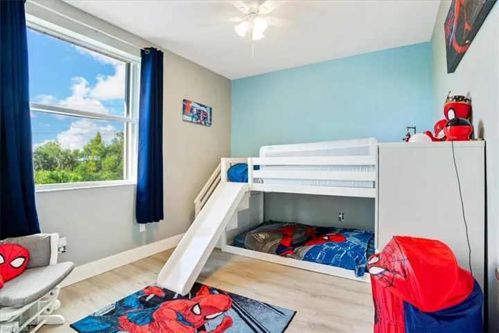 Bedroom with ceiling fan and hardwood / wood-style floors