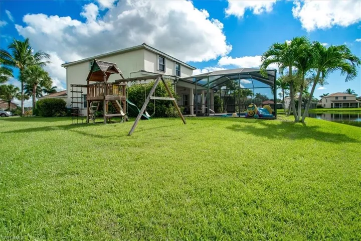 View of yard featuring a playground and a water view
