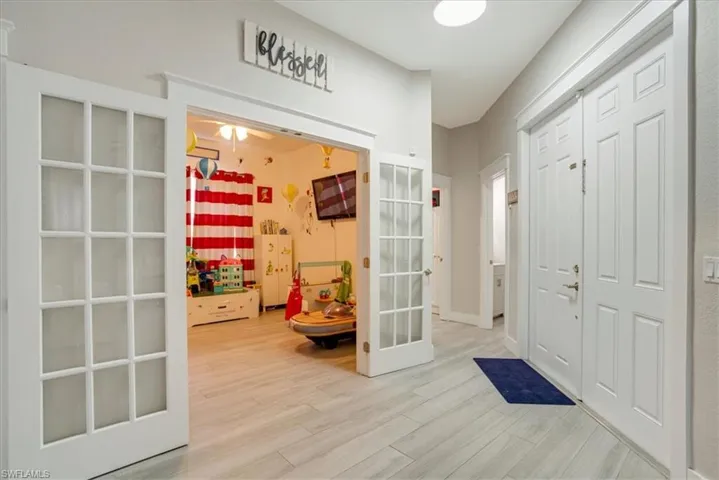 Foyer entrance with light hardwood / wood-style flooring