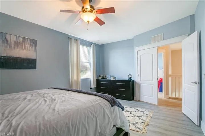 Bedroom with ceiling fan and light hardwood / wood-style flooring