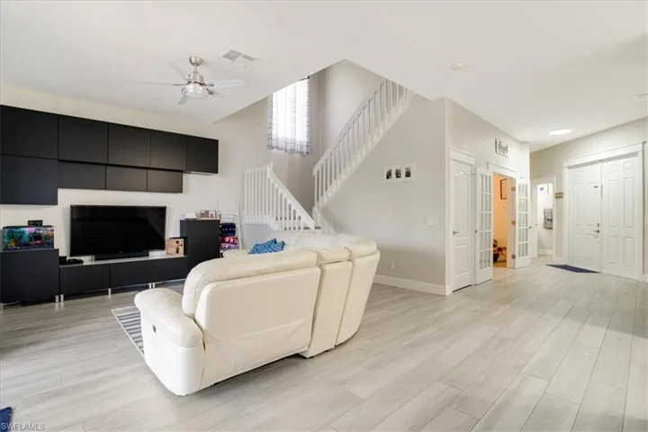 Living room featuring ceiling fan and light wood-type flooring