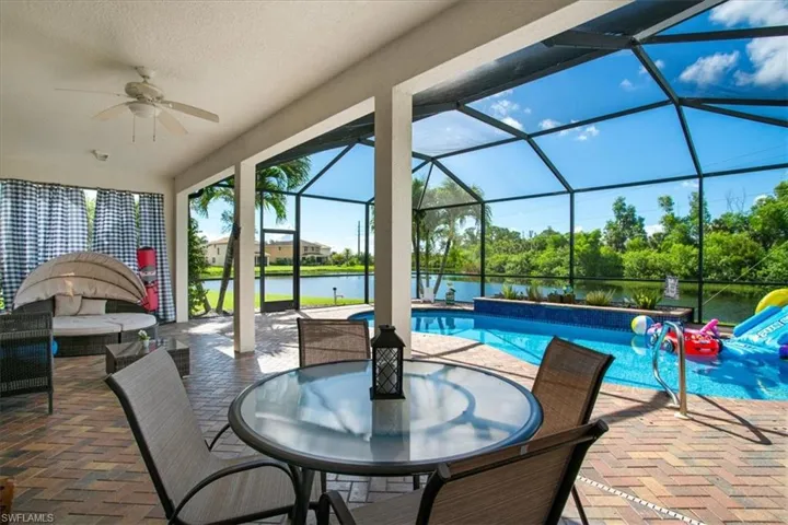 Lanai with ceiling fan and a water view