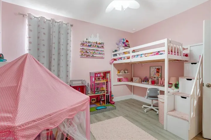 Bedroom with ceiling fan and hardwood / wood-style floors