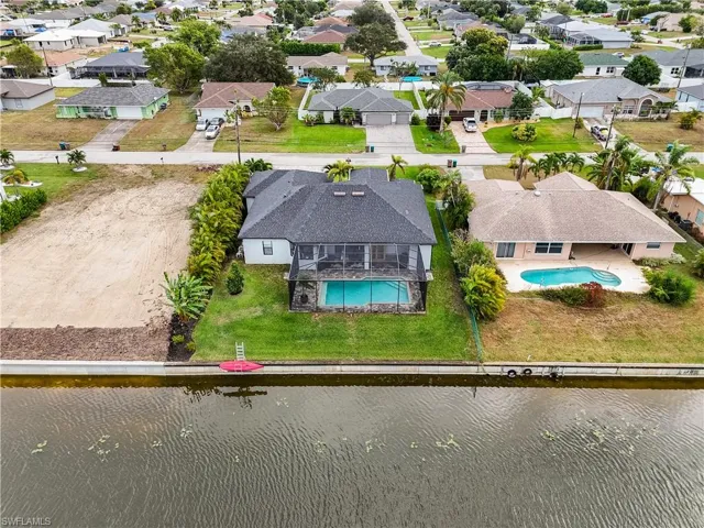 Aerial perspective of suburban area featuring a pool area