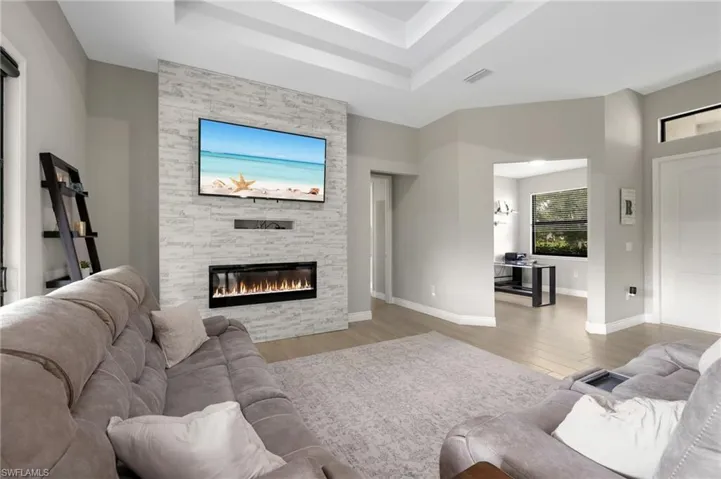 LIVING ROOM WITH STONE ACCENT WALL AND FIREPLACE