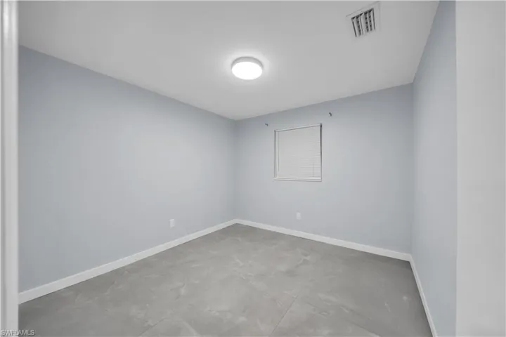 Recessed ceiling light, hard surface flooring, window with blinds, light-toned wall paint, white trim