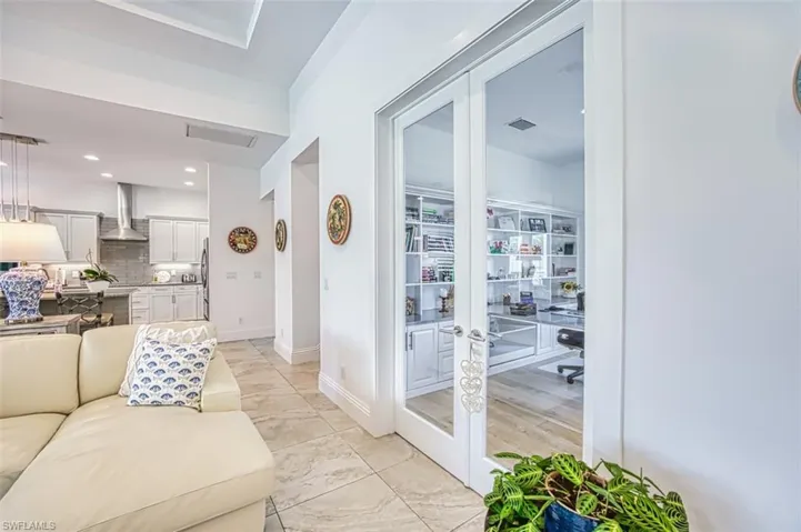Living room featuring french doors, recessed lighting, and an office area