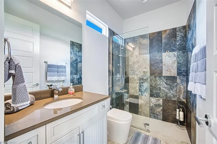 Bathroom with walk in shower and vanity