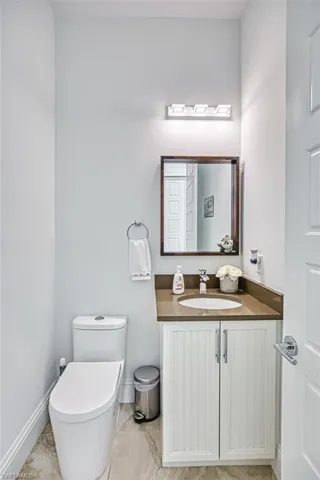 Half bathroom with vanity and toilet