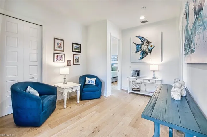 Living area featuring light wood-type flooring and recessed lighting