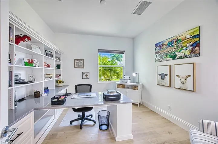 Office featuring baseboards and light wood-type flooring