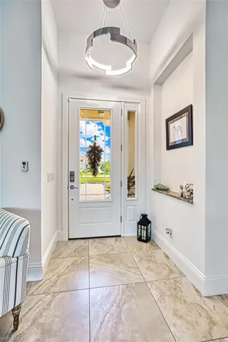 Foyer entrance featuring baseboards and marble finish flooring