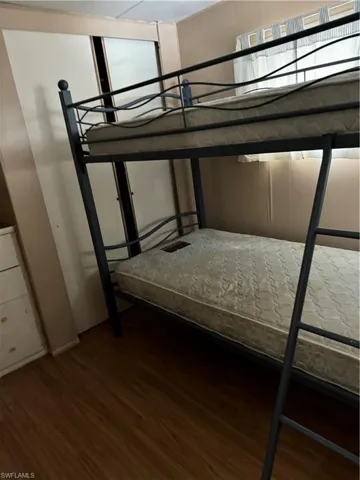 Unfurnished bedroom with wood-type flooring