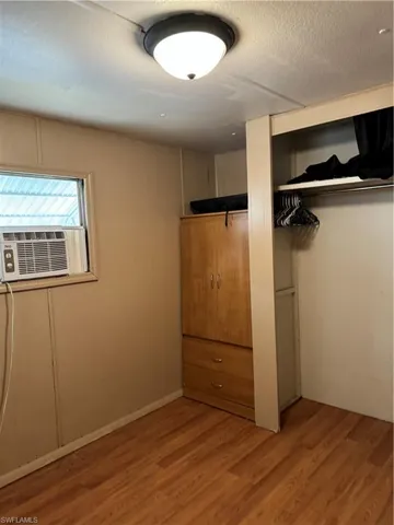 Unfurnished bedroom with hardwood / wood-style flooring