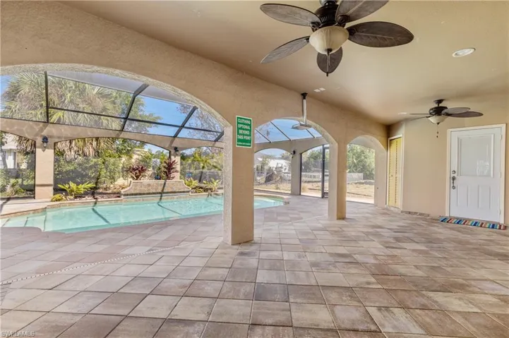 Outdoor pool featuring a patio area, a sunroom, and a lanai