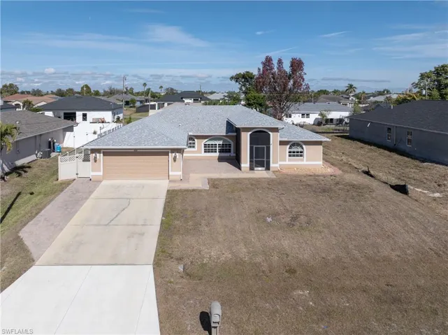 View of front of house featuring concrete driveway, a residential view, a shingled roof, and an attached garage