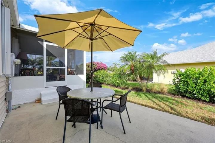 View of patio with a sunroom