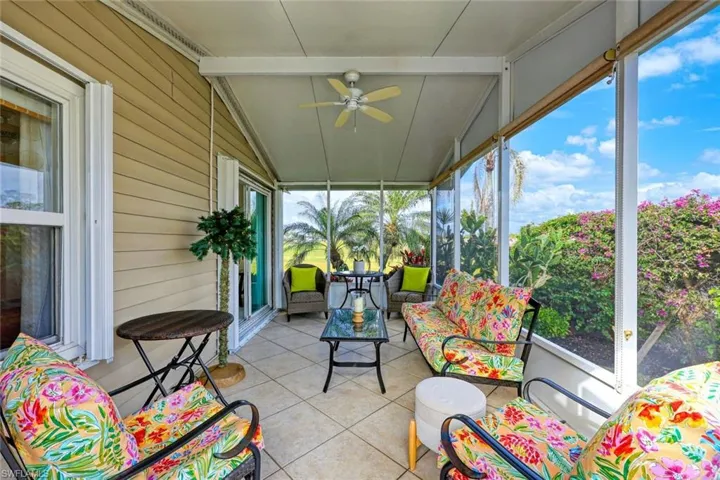 Sunroom / solarium with vaulted ceiling with beams and ceiling fan