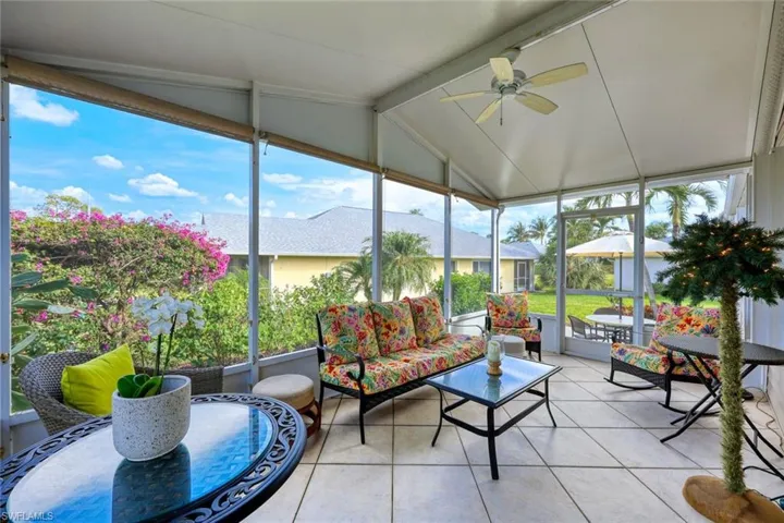 Sunroom / solarium featuring vaulted ceiling with beams and ceiling fan