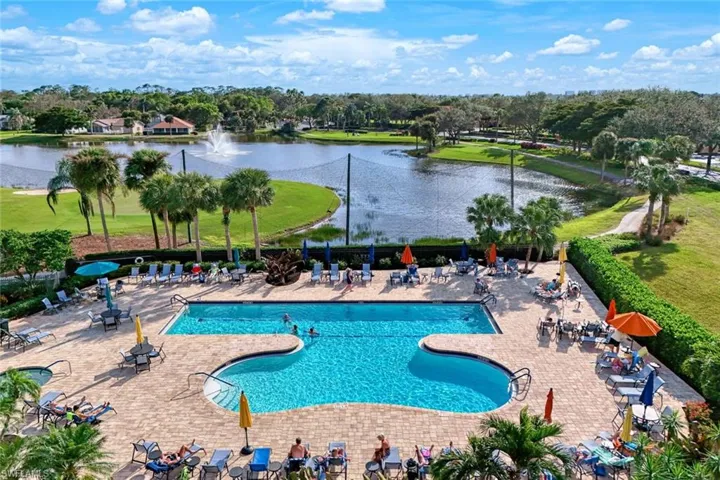 View of pool with a patio area and a water view