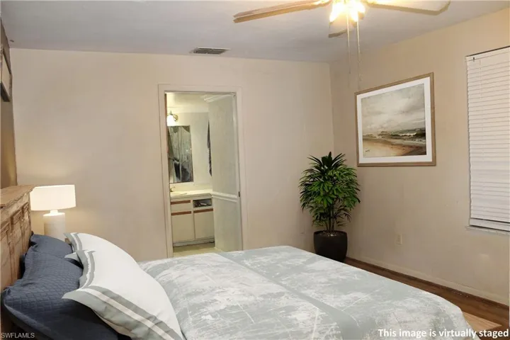 Bedroom with wood finished floors and ceiling fan