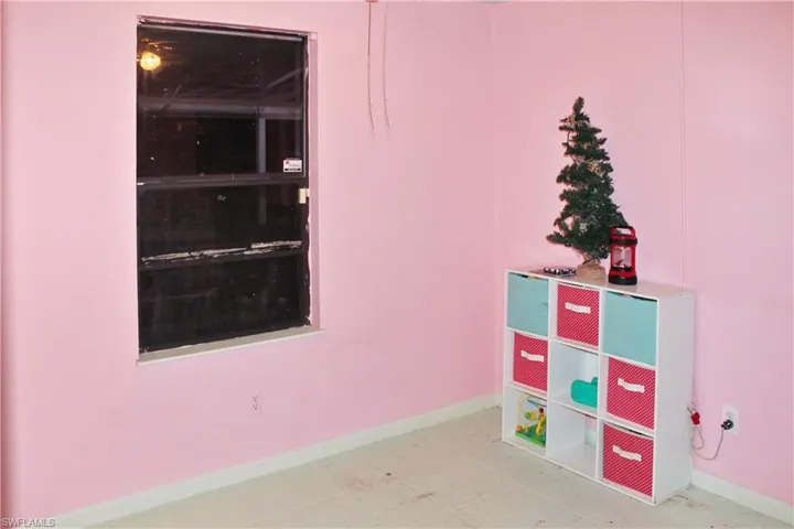 Game room with baseboards and tile patterned floors