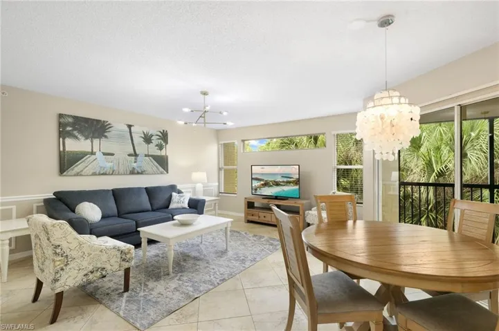 Beautiful Living Room with Transom Window, Decorative Wall Mouldings and Slider to Screened Balcony