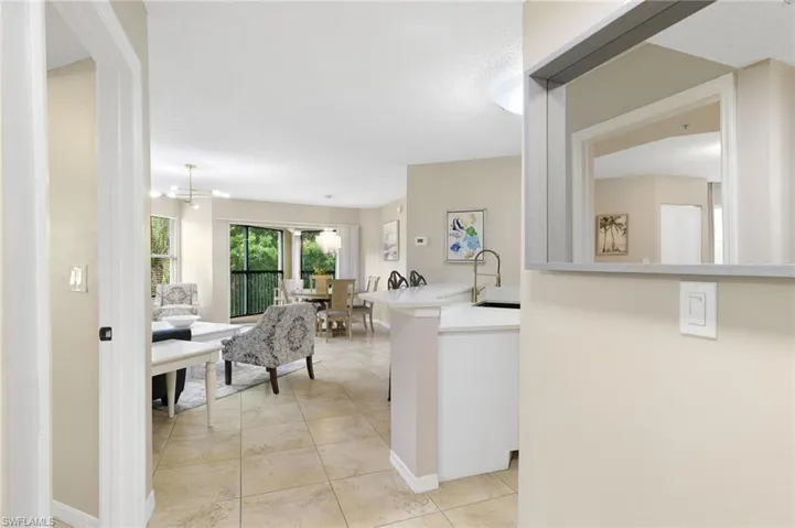 Foyer to living, dining and kitchen areas. Full Bath to left with door to Bedroom.