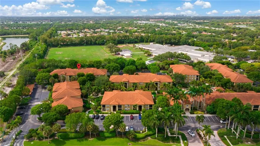 Gated Entrance from Bernwood Parkway just off 41 in Bonita Springs. Red tab marks condo building. To left is potentially the future Bonita Estero Rail Trail/BERT for biking and walking! Spring Run Elementary School green area on other side of trees and marker.