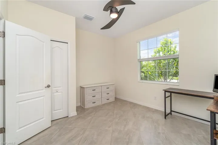 Unfurnished bedroom featuring ceiling fan and light tile patterned floors