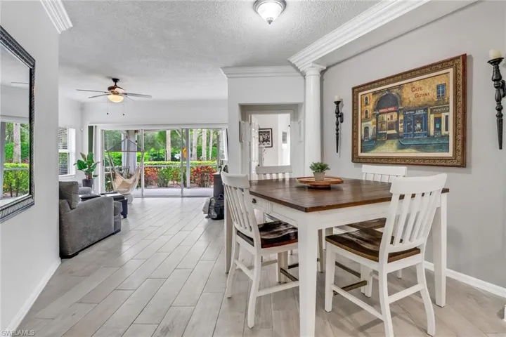 Dining space with ornamental molding, a textured ceiling, ceiling fan, and plenty of natural light