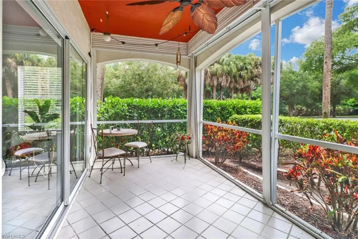 Unfurnished sunroom featuring ceiling fan