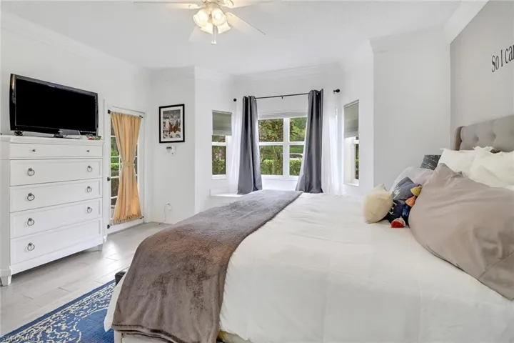 Bedroom featuring crown molding, ceiling fan, and light hardwood / wood-style floors