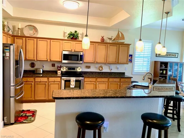 Open kitchen with lots of natural light, granite, pantry, breakfast bar, pull-out drawers, kitchen nook, SS appliances & has a fantastic waterfront view!