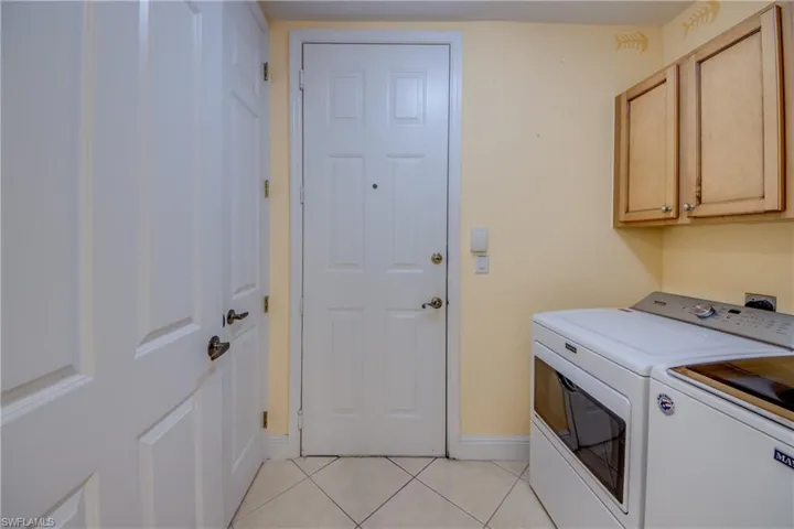 Maytag washer & dryer, extra cabinets & storage closet.
