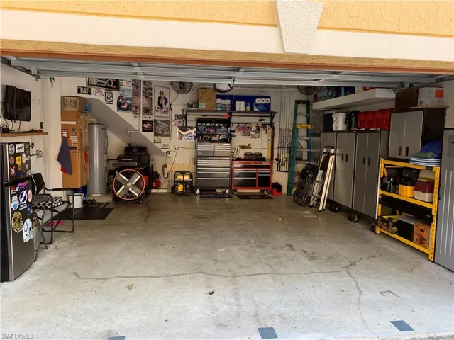 Seller's man-cave! 2 Car garage before sellers moved out. Lots of custom storage above garage door too!