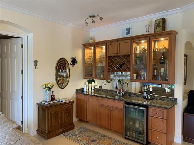 Custom built-in wet bar with wine rack, wine cooler, glass shelving with lights!!