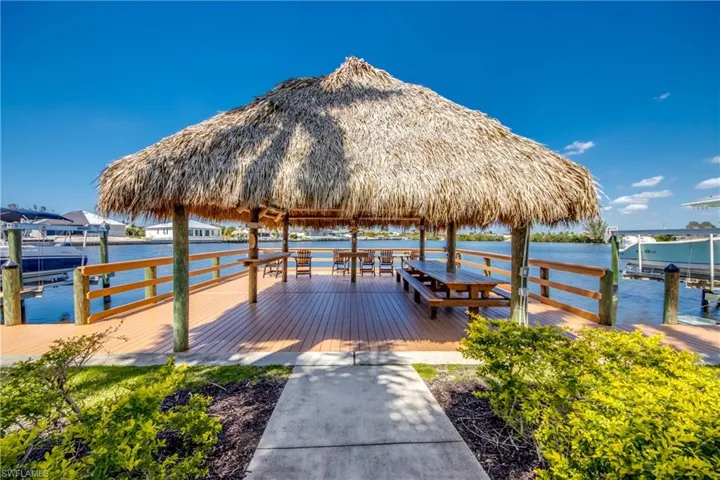 Tiki hut with benches overlooking the water.