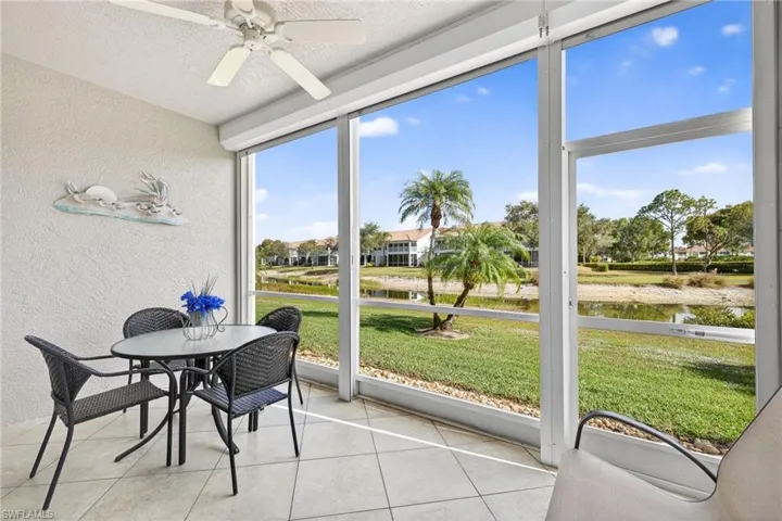 Sunroom featuring a water view and a ceiling fan