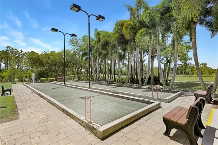 View of community with a game area and view of wooded area